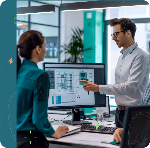 Man explaining technical drawings displayed on a computer monitor to a woman in an office setting.