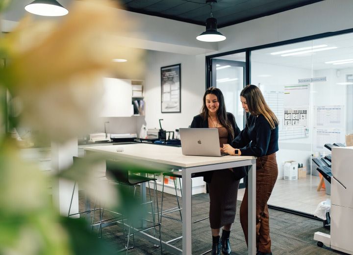 People working on laptop at table