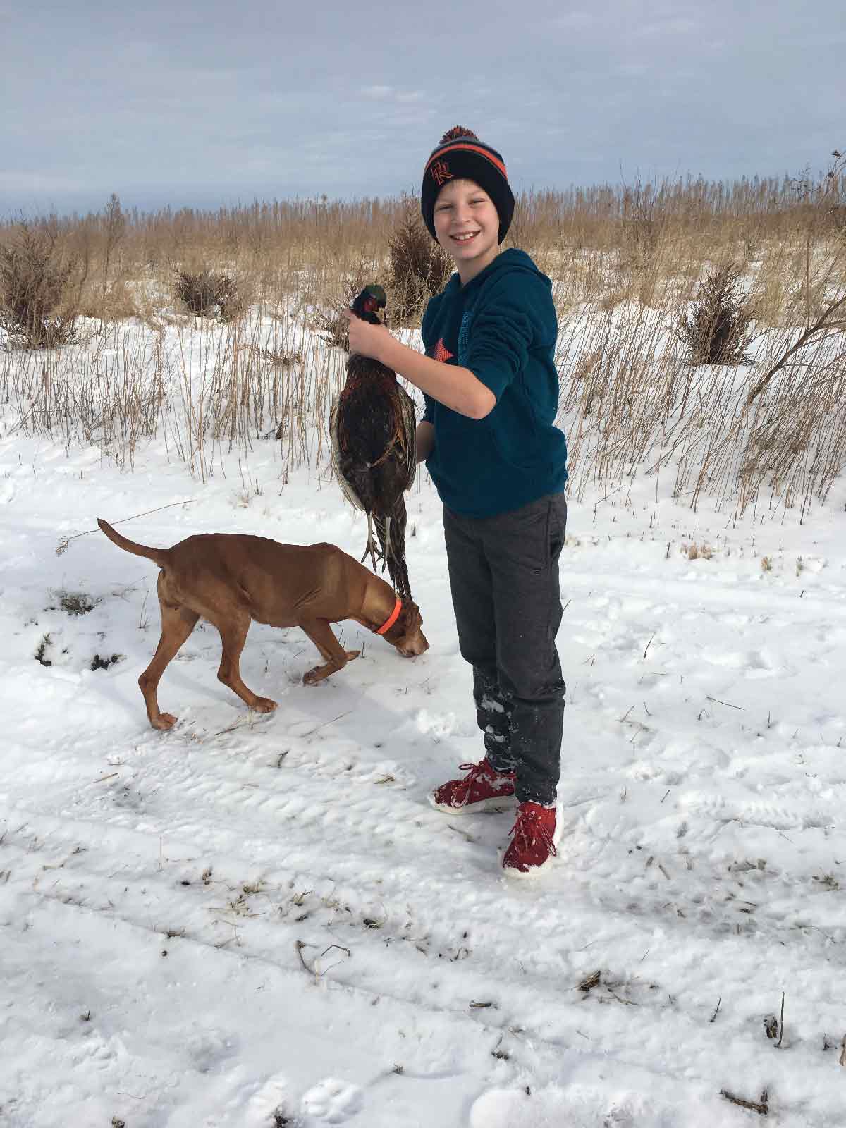 youth hunter with pheasant