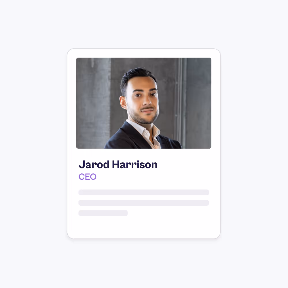 Portrait of a smiling man with short black hair and beard wearing a white shirt and dark jacket.