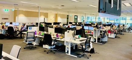 A photo of one of the customer contact centre offices showing people working at their desks. 