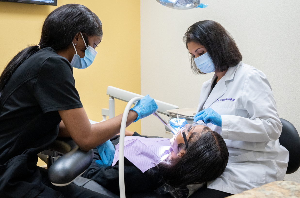 A dentist performing cleaning.