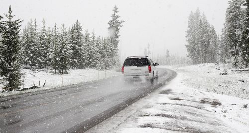 Winter driving scene with a car navigating through snowy roads