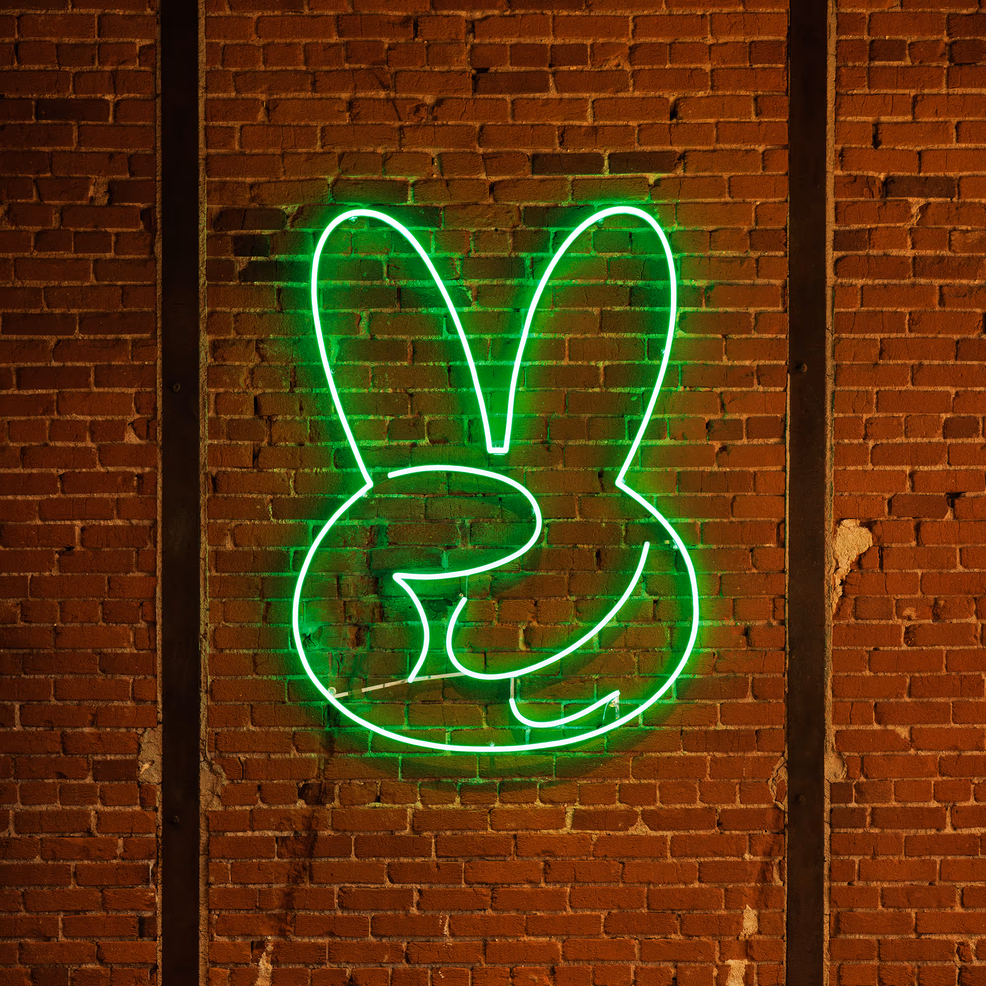Jade Rabbit Neon Logo on a brik Wall