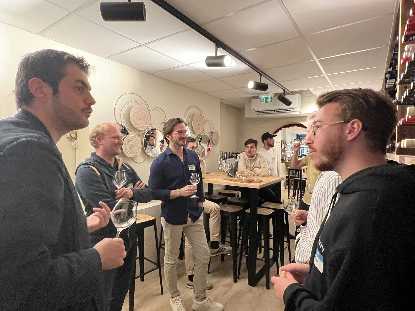 Members chat standing up during an evening in Bordeaux