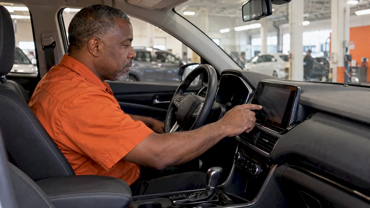 Worker clearing rental car infotainment data