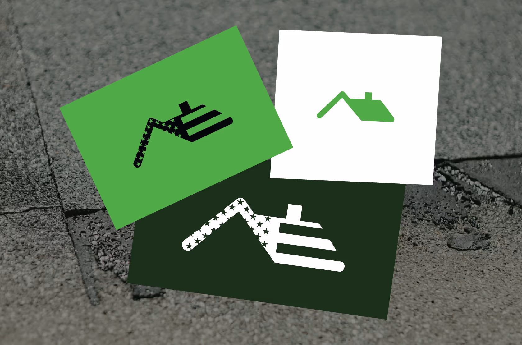 Three overlapping rectangular cards on a rooftop surface, each displaying a stylized house roof icon with stripes and stars in green, white, and black colors.