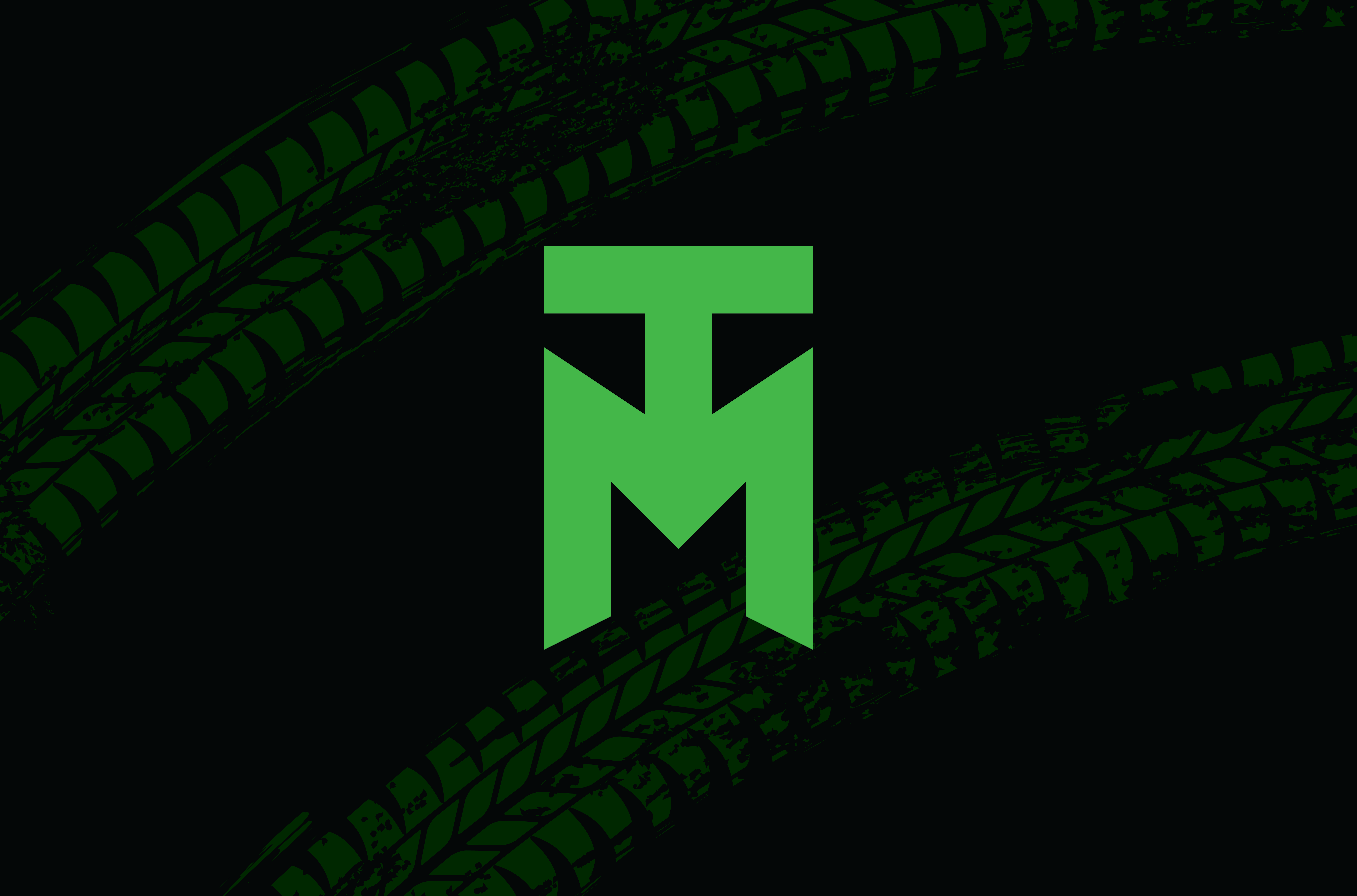Green stylized T and M letters forming a logo over a dark background with green tire tread marks.