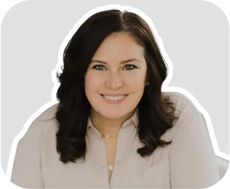 HeyOrca user Darcy's headshot, smiling, on a grey background.