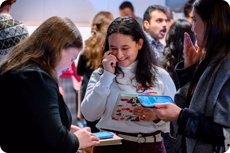 A group of people network at a conference.