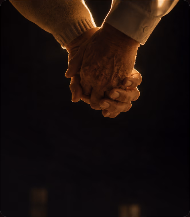 An older couple holding hands