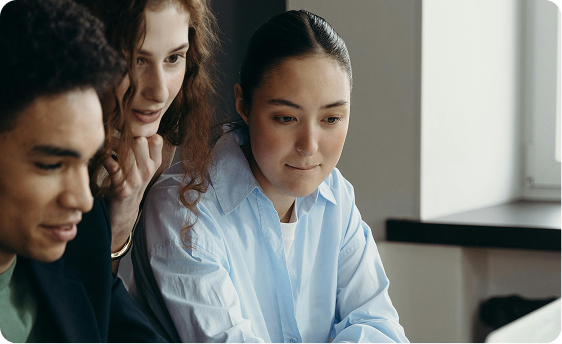 Group of three looking at a computer screen