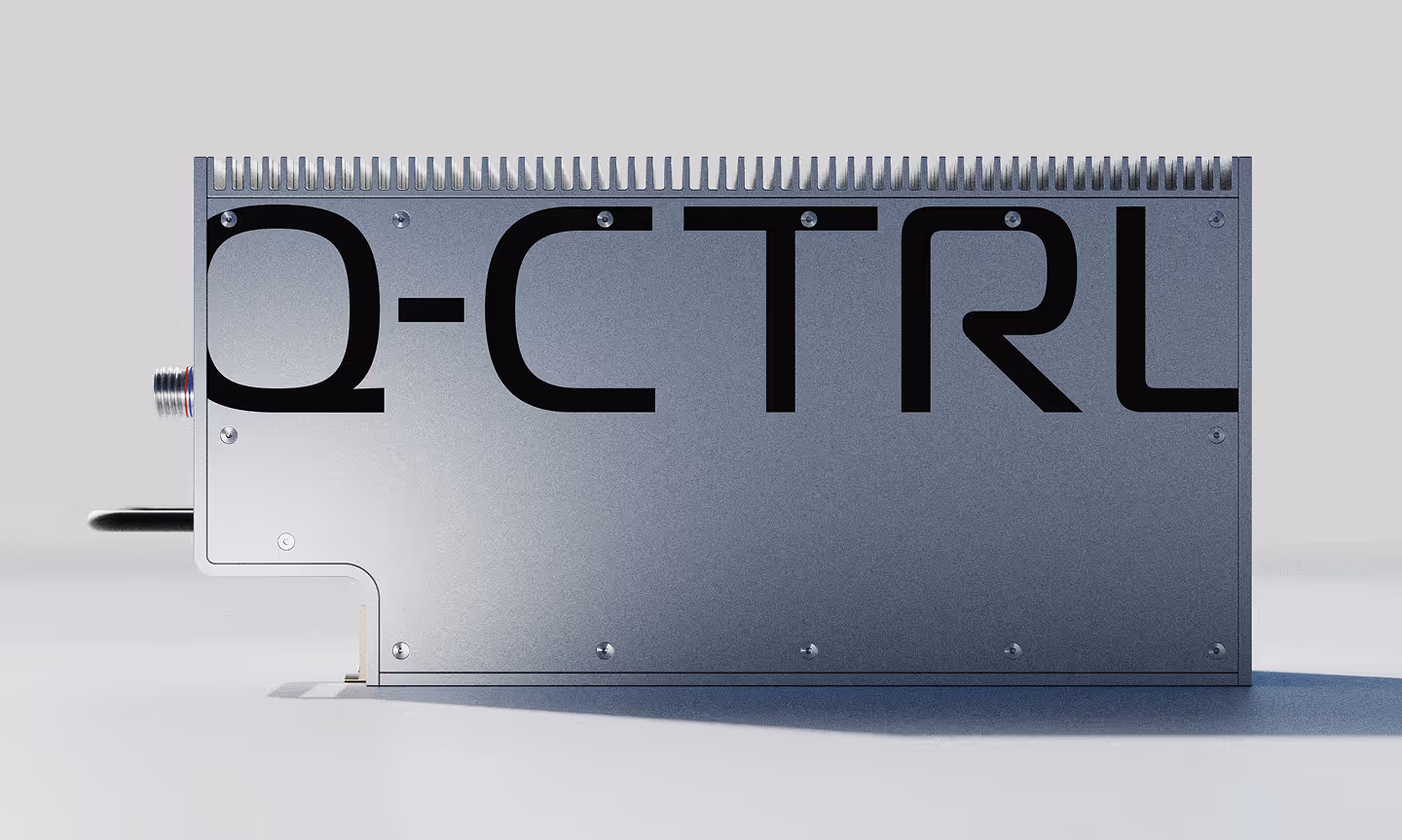 Metal rectangular avionics computer with fins on top and the text 'Q-CTRL' printed in large black letters on its side.