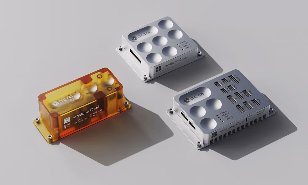 Three Ironstone Opal electronic devices with metallic and amber casings on a gray surface.