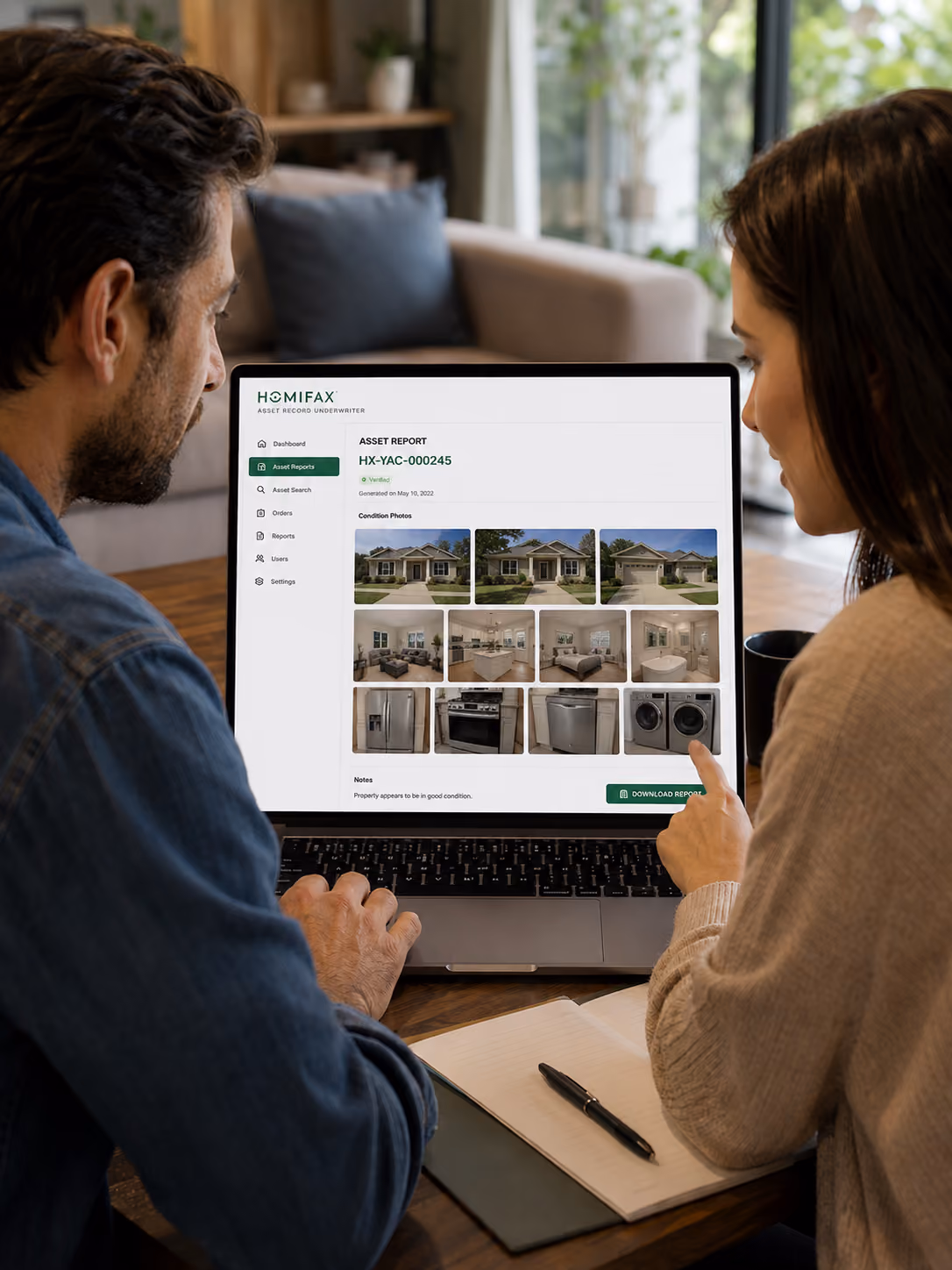 Man and woman reviewing a property asset report with home photos on a laptop.