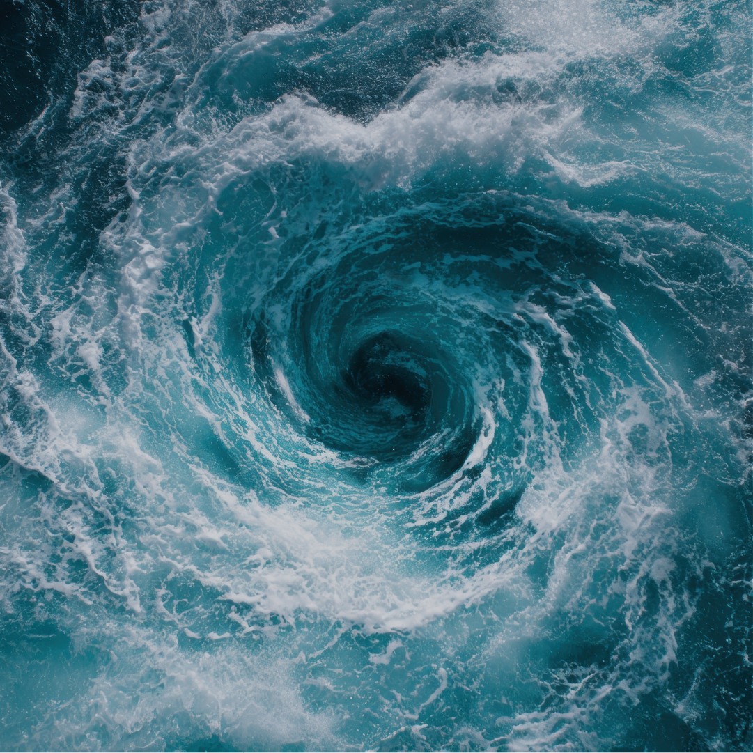 A swirling ocean whirlpool with frothy white waves and deep blue-green water spiraling toward a dark center.