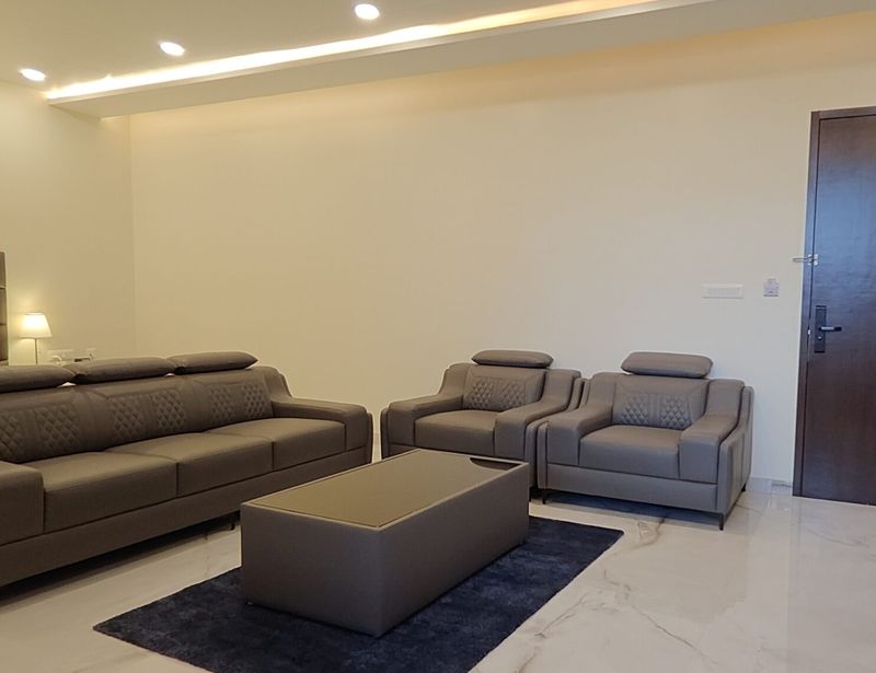 Hotel room lounge with leather sofas for families near Manyata Tech Park