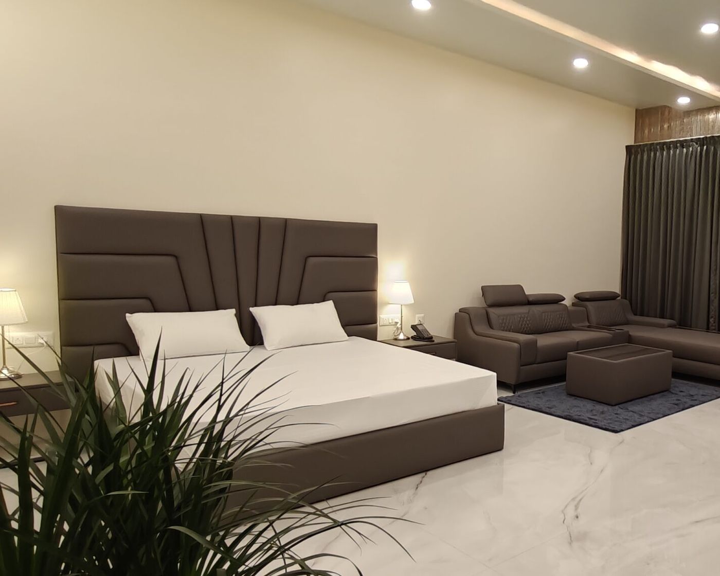 Hotel room with king bed and sofa seating at Yello Stays Manyata, Thanisandra