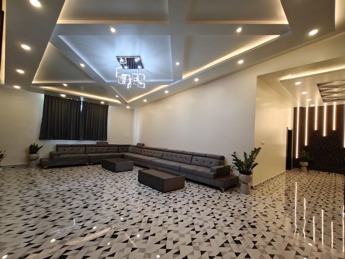 Cirrus 3BHK penthouse with a large living room, sectional sofas and feature lighting