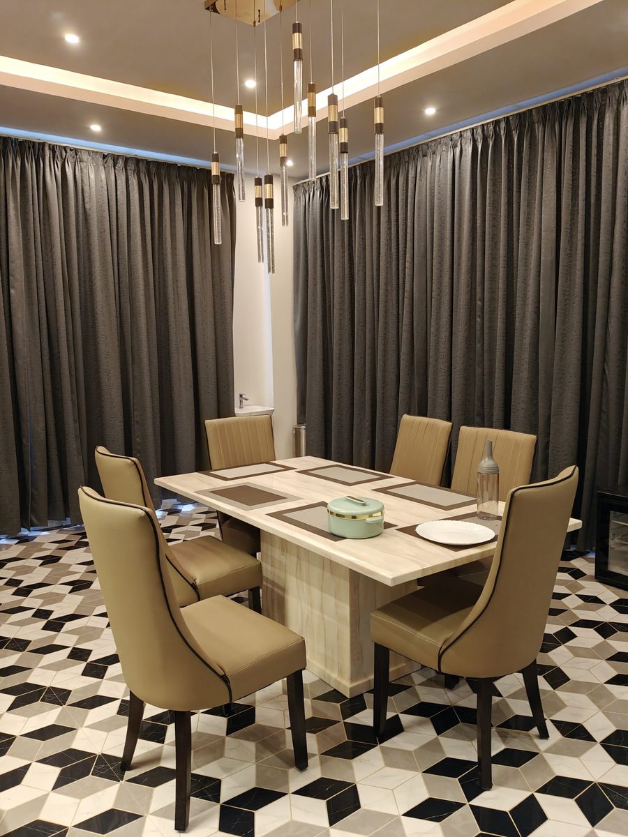 Penthouse dining table with six chairs and pendant lights