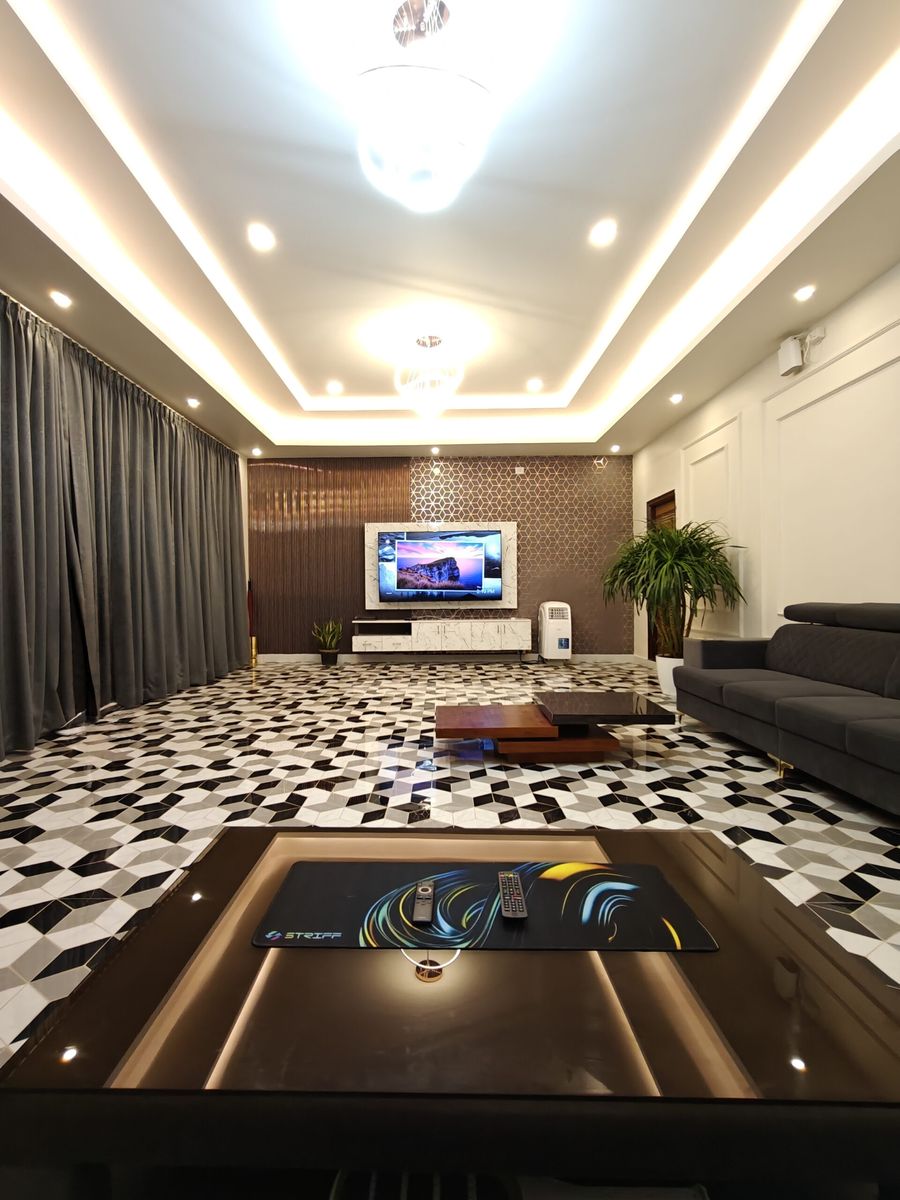 Penthouse lounge with sectional sofa and patterned marble floor