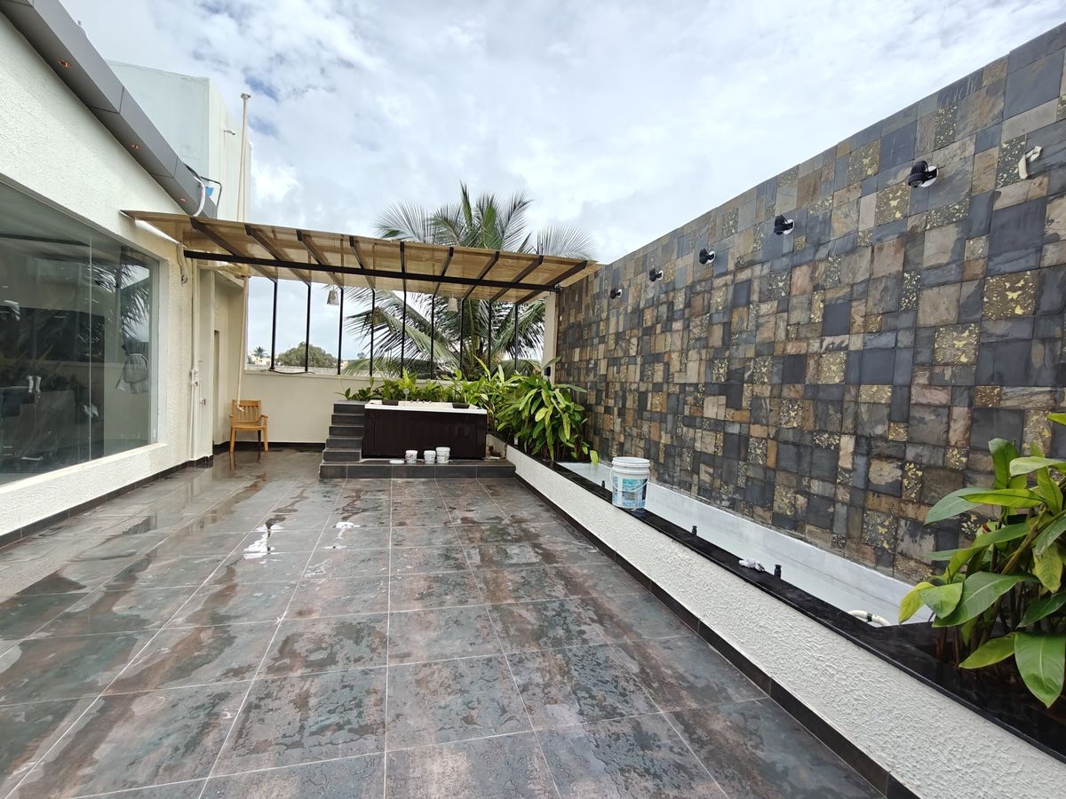 Sky Deck rooftop terrace with stone water wall, pergola and open sky for parties in Bangalore