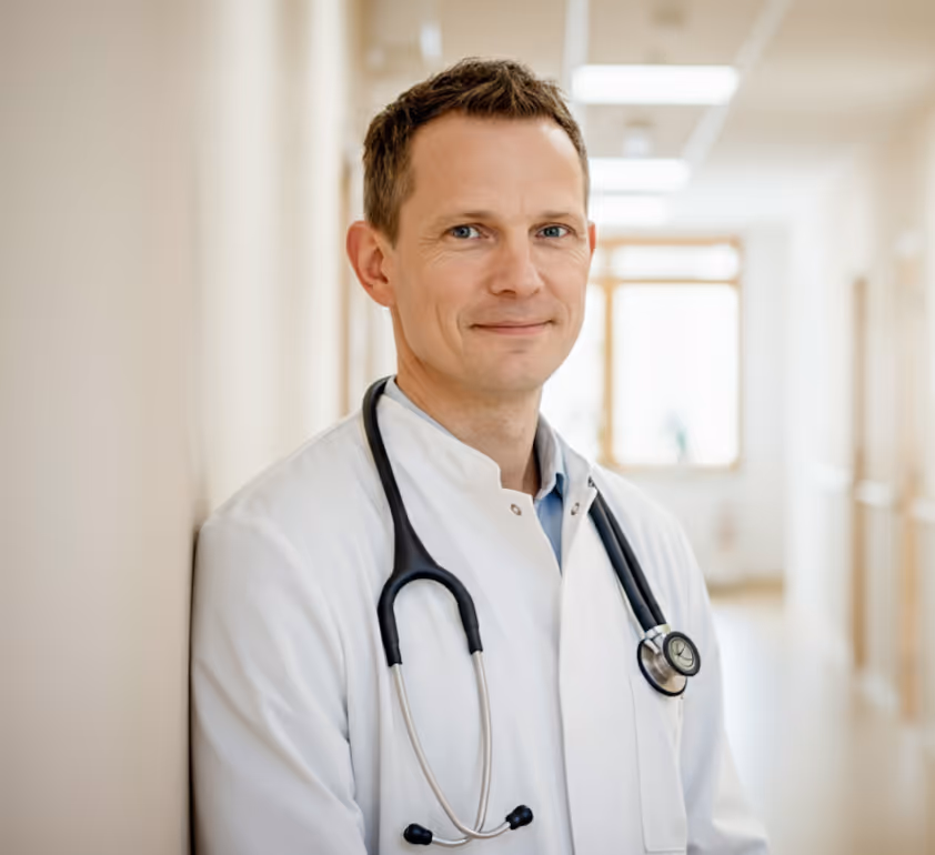 A male doctor in a white coat and stethoscope.