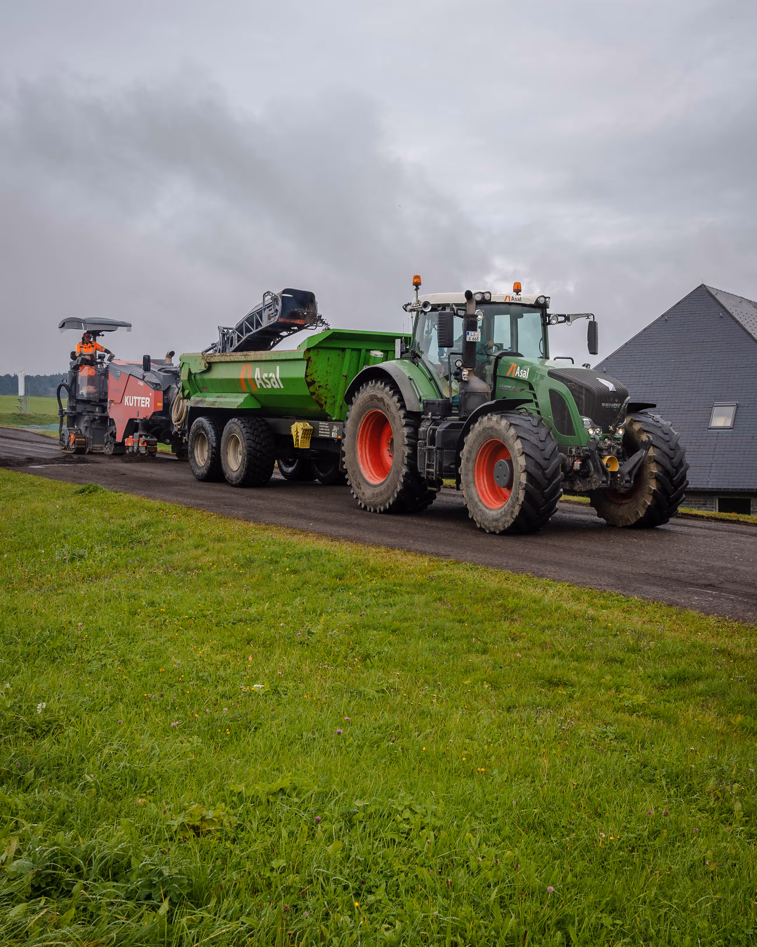 Traktor mit Muldenanhänger im Einsatz beim Straßenbau