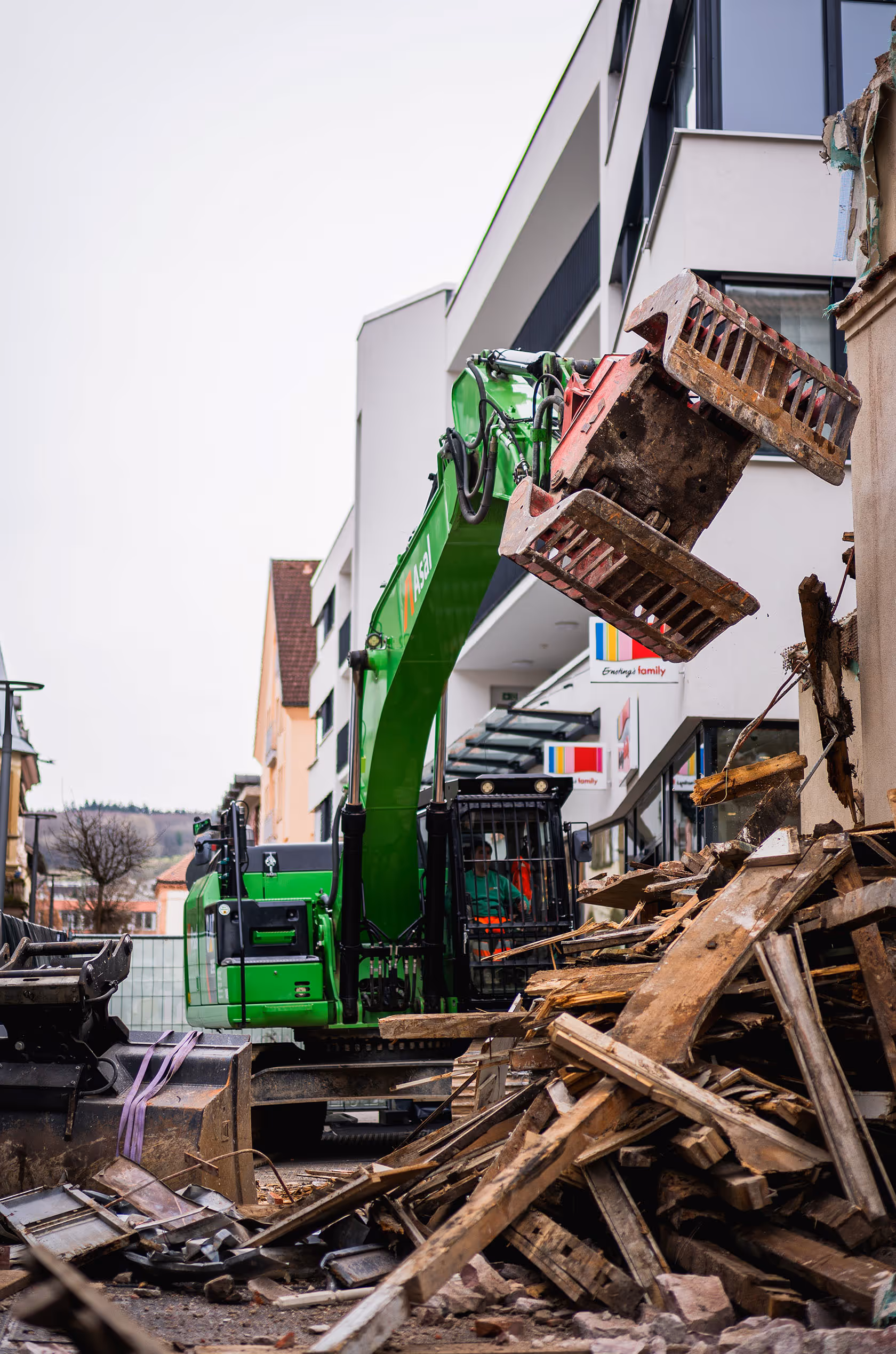 Bagger reißt Hauswand ein, Trümmer auf dem Boden, Innenstadtlage