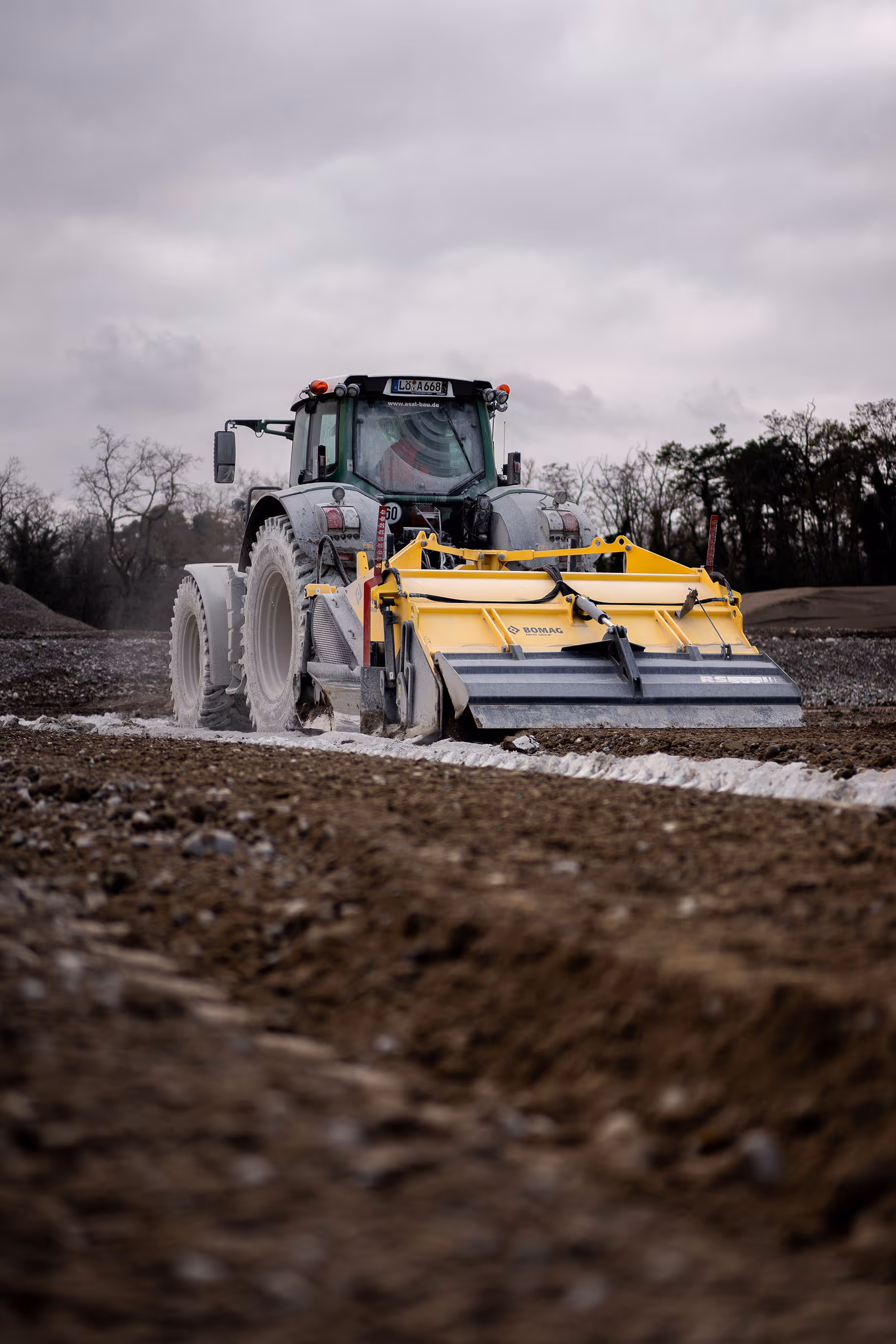Landmaschine mit Bodenfräse auf Baustelle zur Bodenverbesserung.