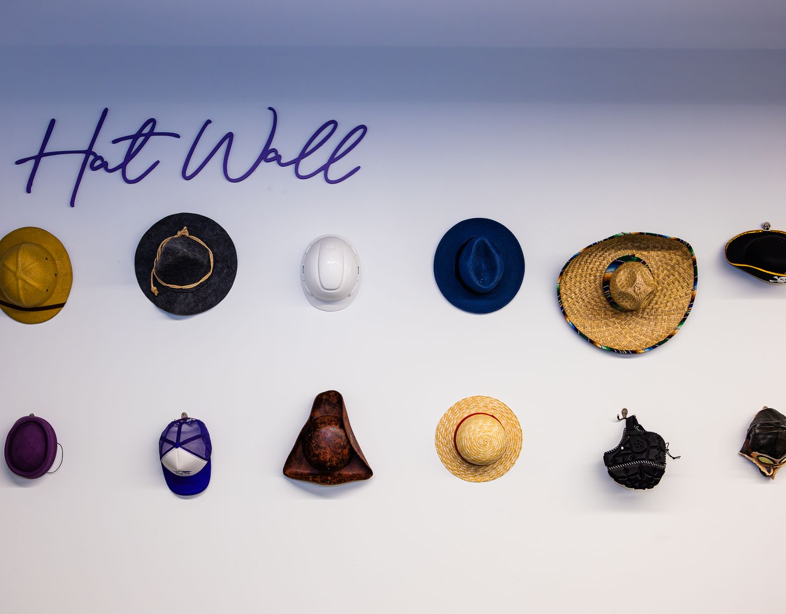 The BigHat hat wall, a collection of hats hung in the office