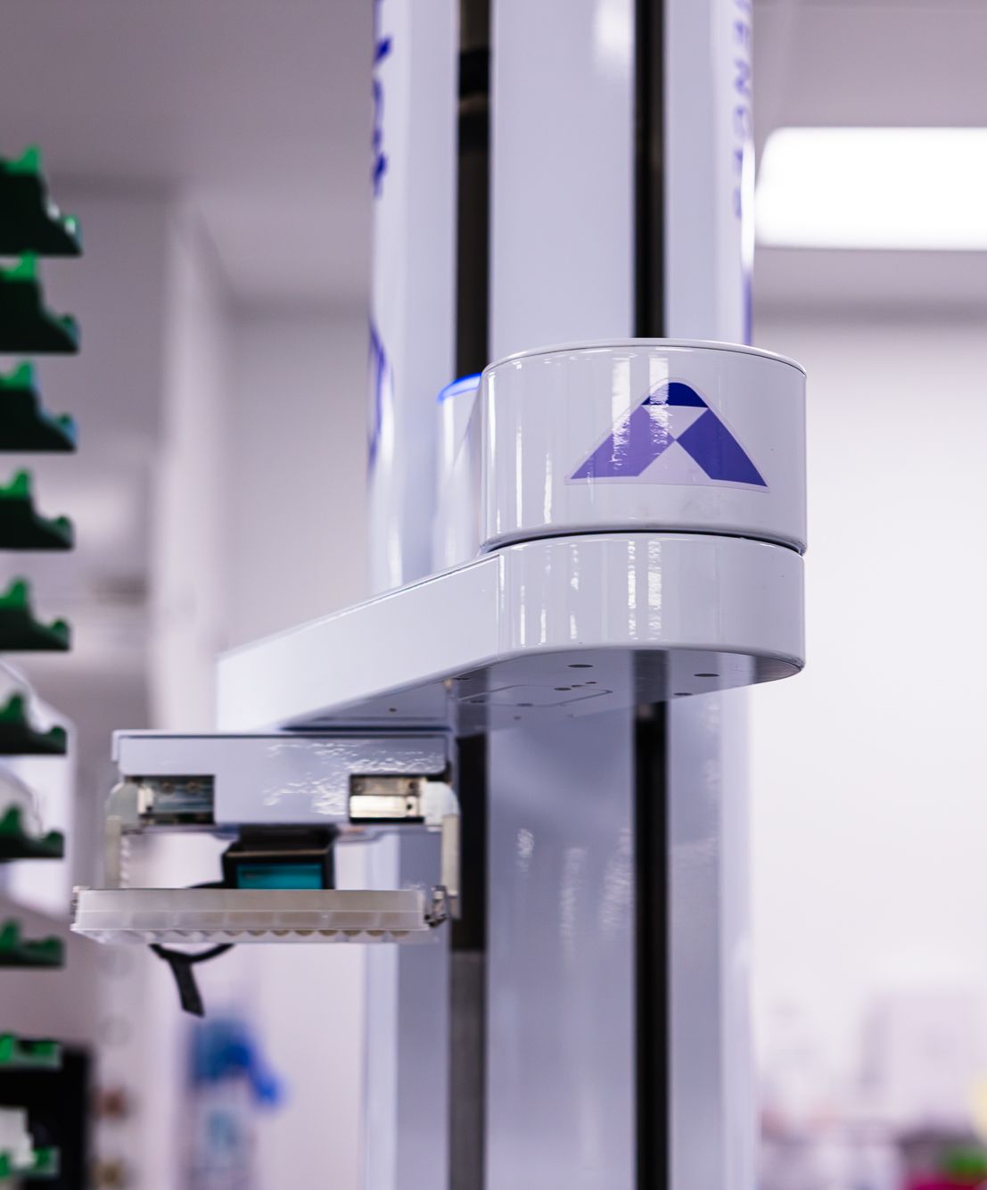 BigHat-branded robotic arm in the automated lab