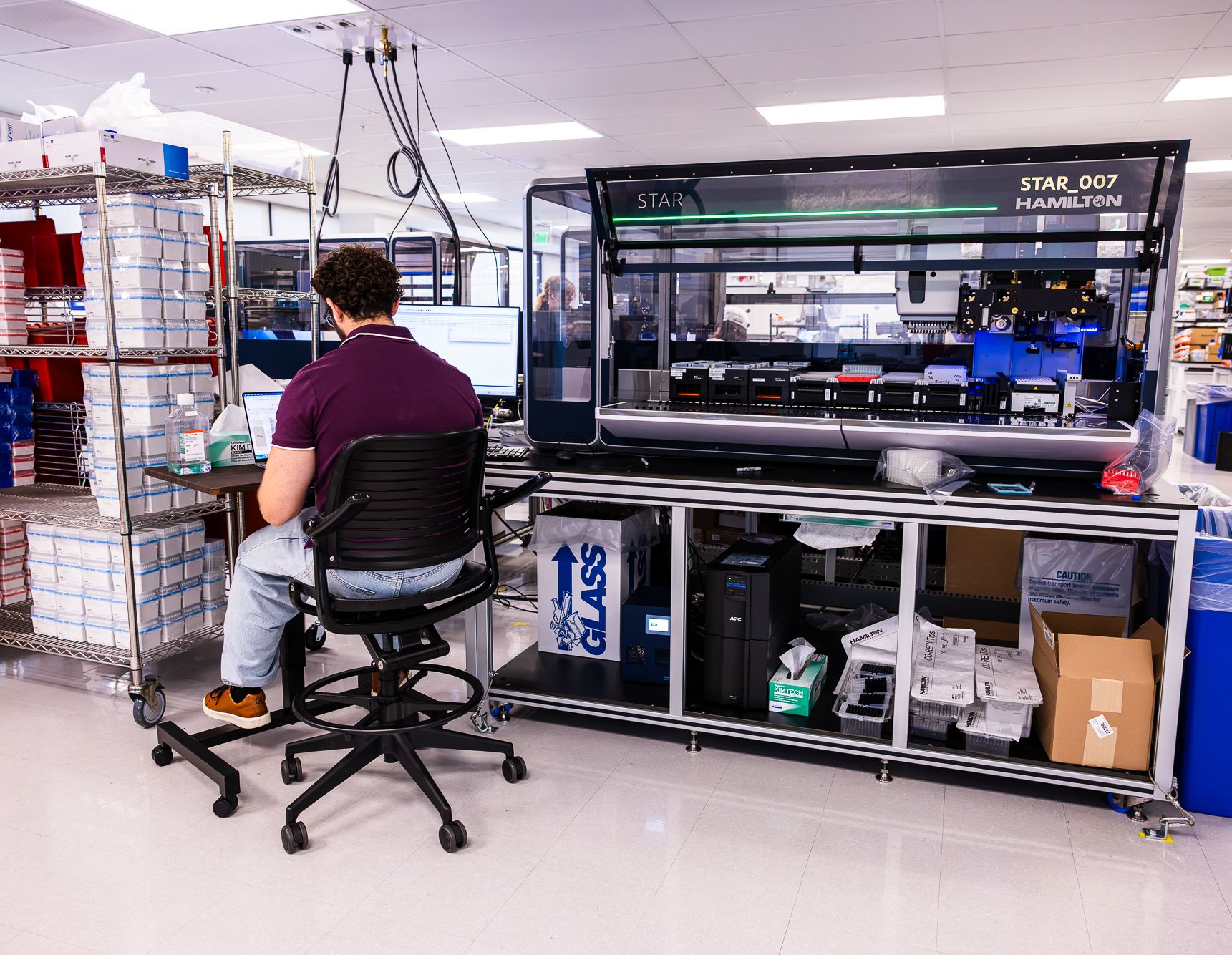 Scientist at a Hamilton STAR liquid-handling system in the BigHat lab