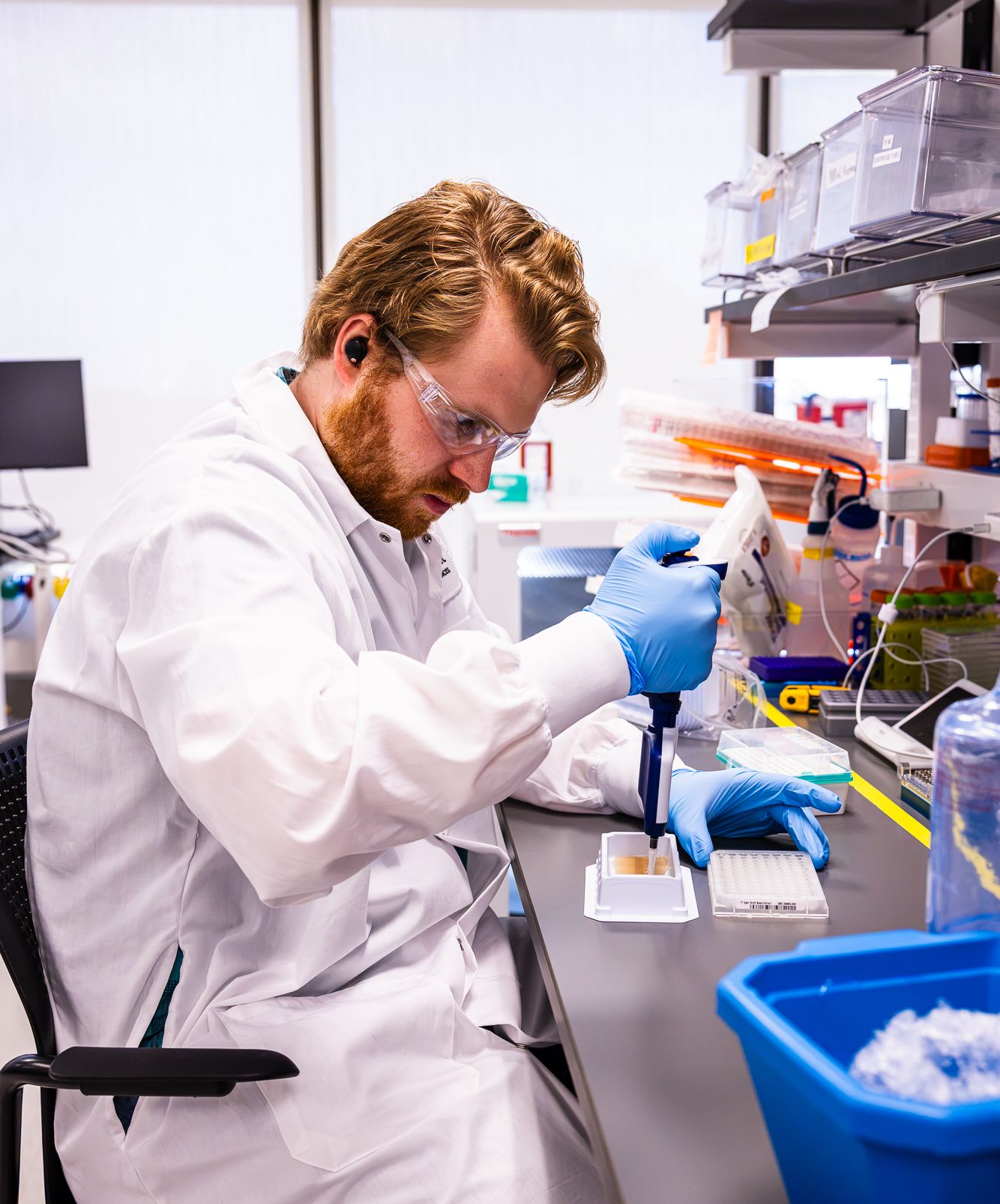 BigHat scientist pipetting samples at a lab bench