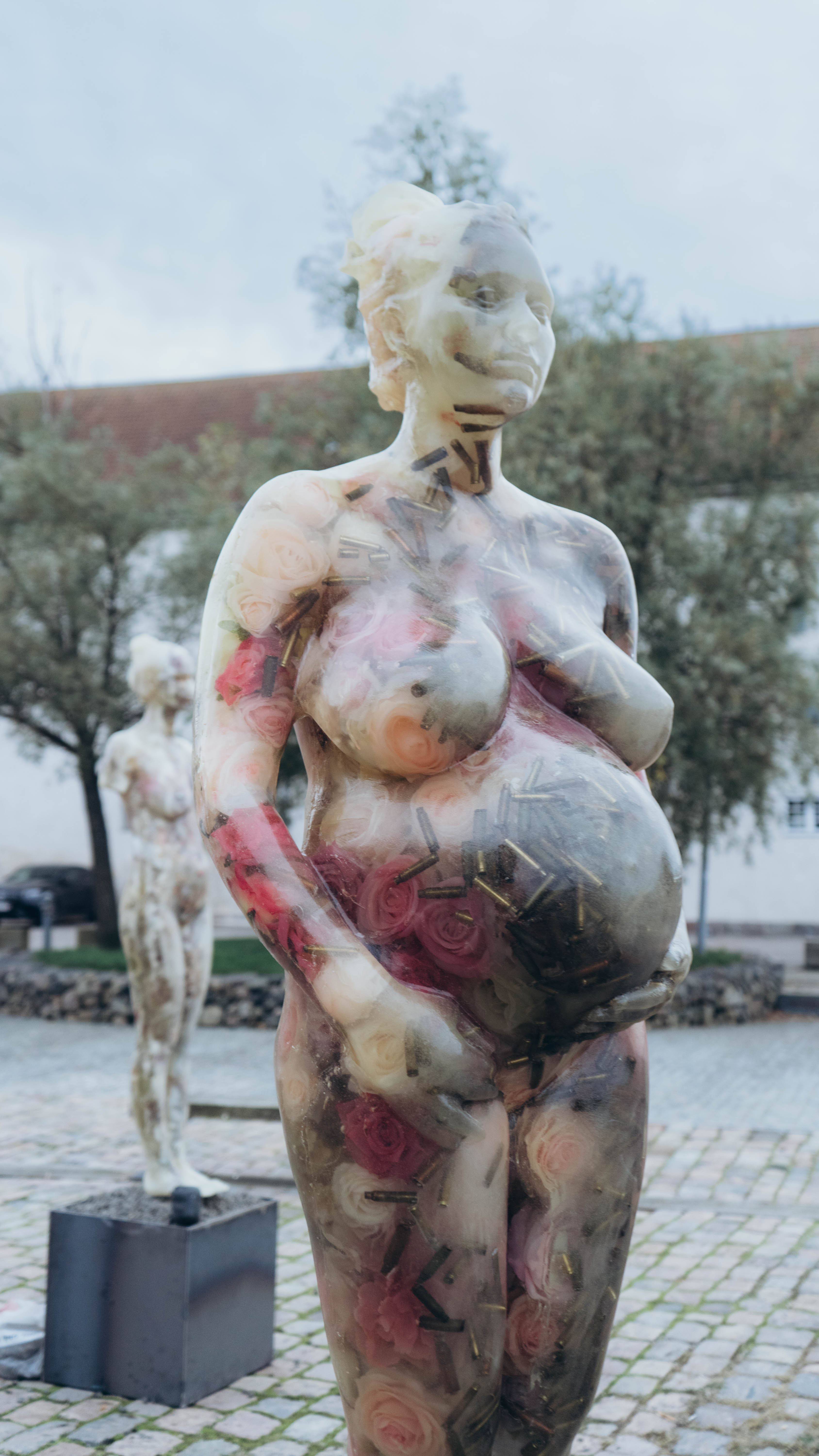 Epoxy resin, artificial roses and flowers, shell casings from Izium; cast of the artist’s pregnant body, made five months before the full-scale invasion 2024.  Photo by Anastasiia Ovsiienko 