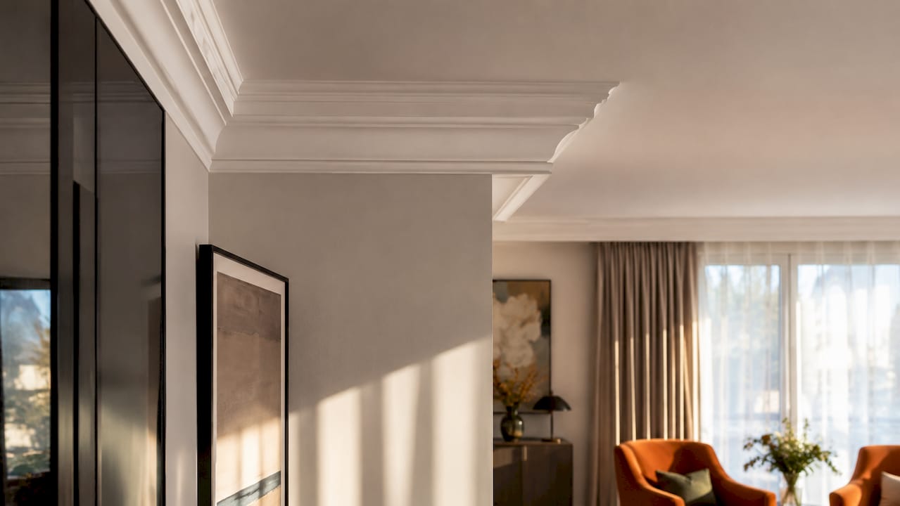 Detailed layered crown molding in Zollikon home ceiling