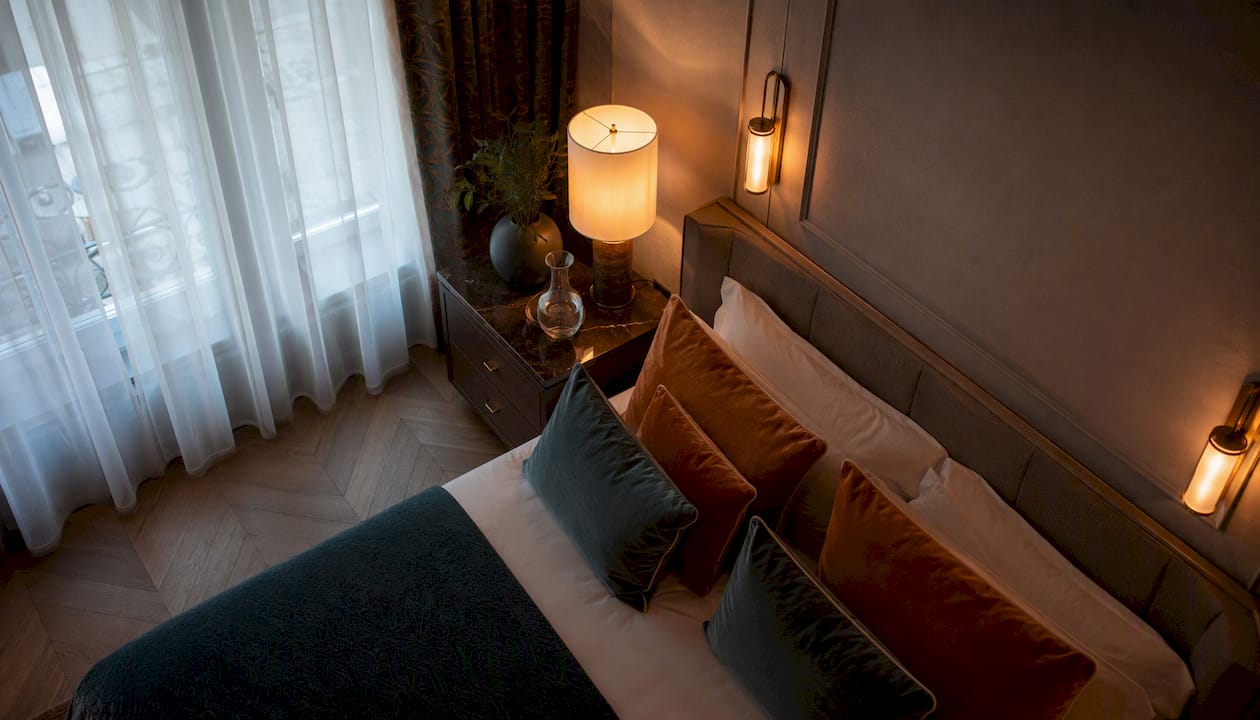 Hotel style layered lighting in bedroom corner