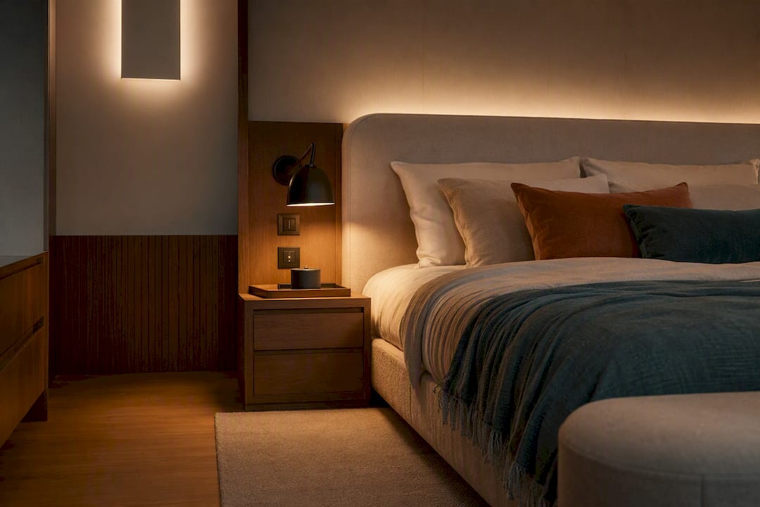 Layered tunable lighting in luxury bedroom