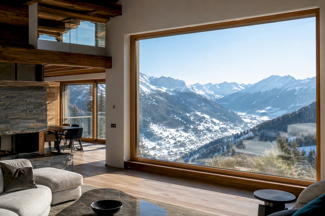 Enlarged chalet glazing framing alpine mountain views