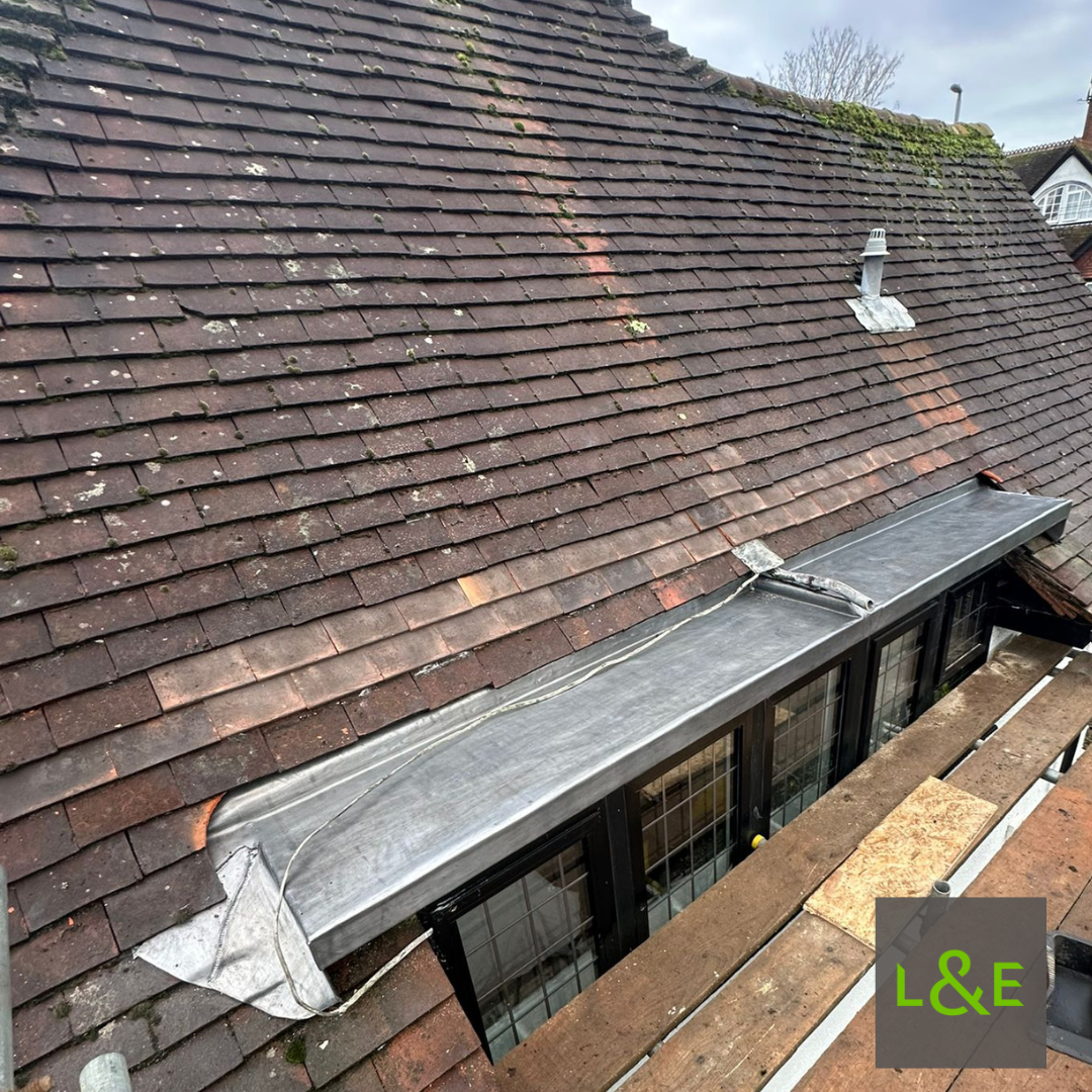 Detailed Code 5 leadwork forming dormer roof tops on an older residential property in Maidenhead