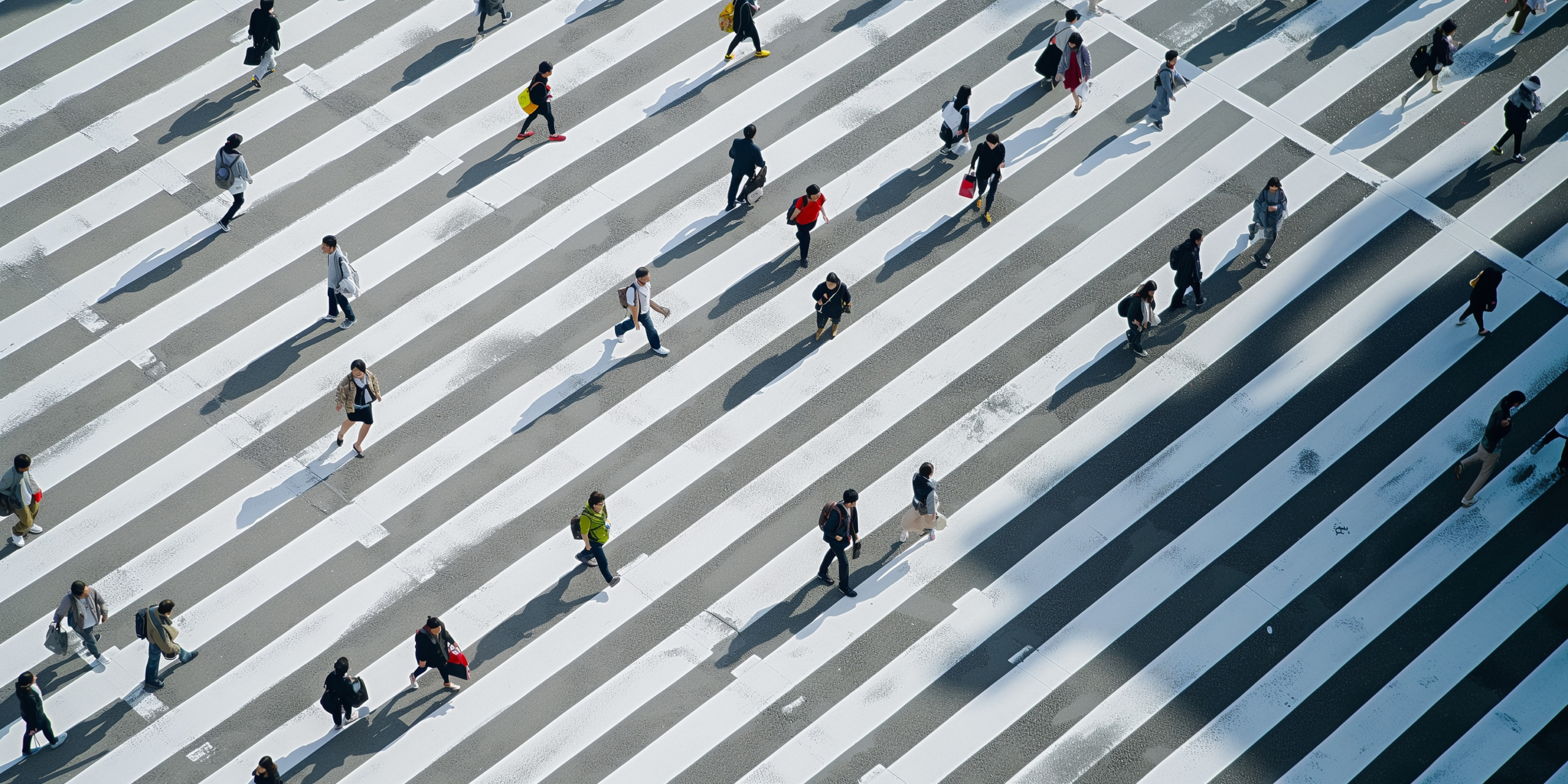 Aerial view of people walking across a large crosswalk