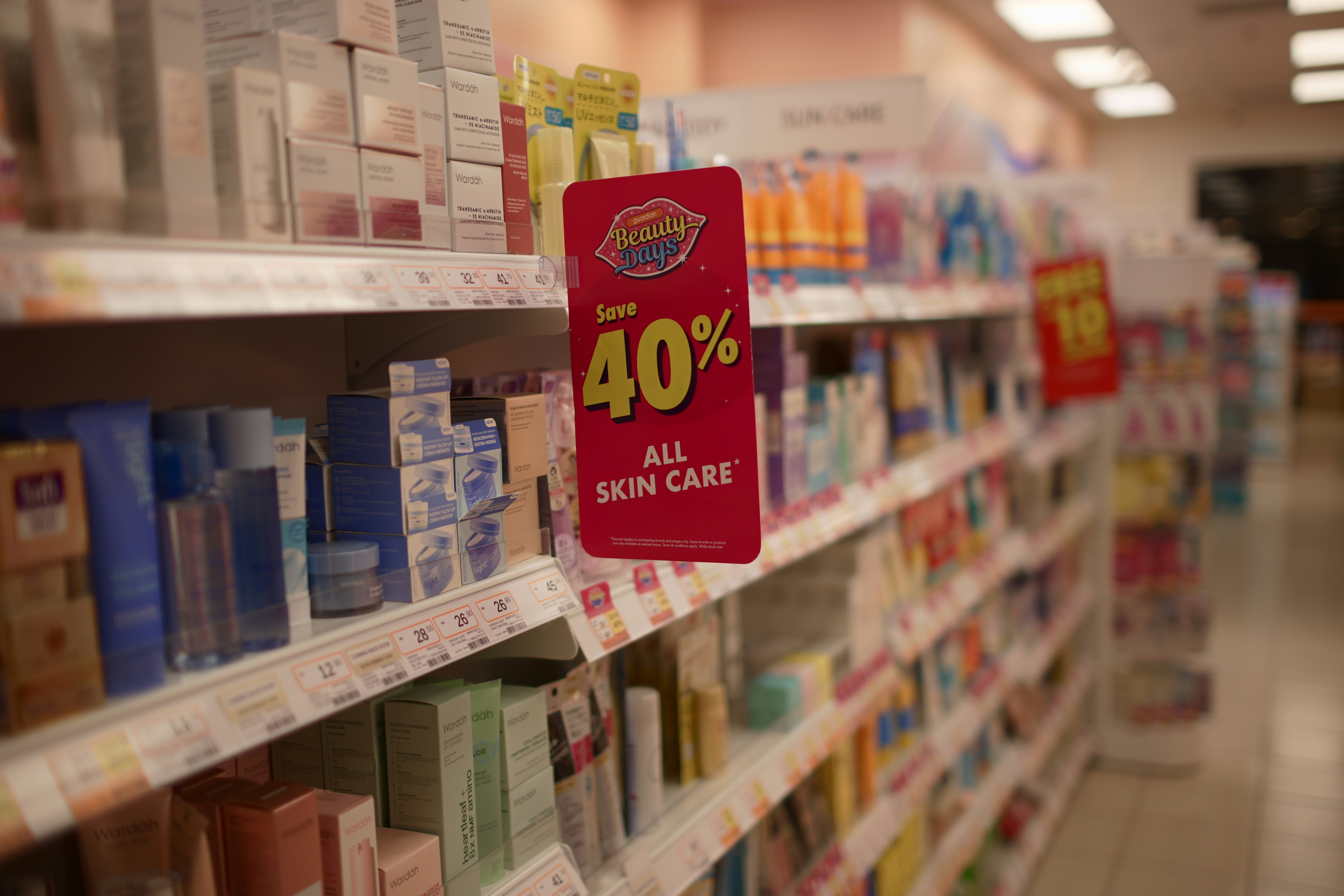 Closeup of drugstore shelf with promotional sign for 40% off