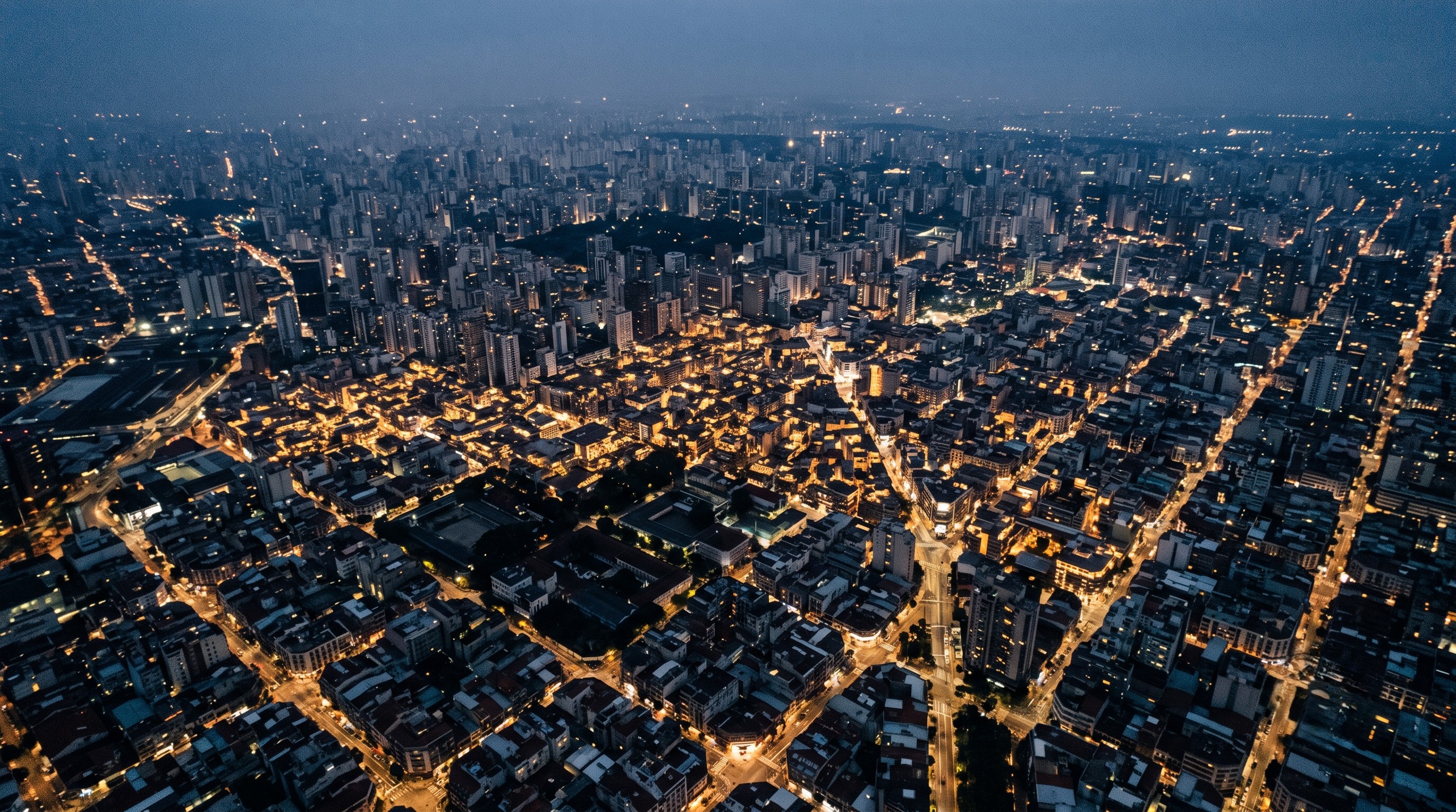 Aerial view of cityscape at night with clearly identifiable main streets bisecting one another
