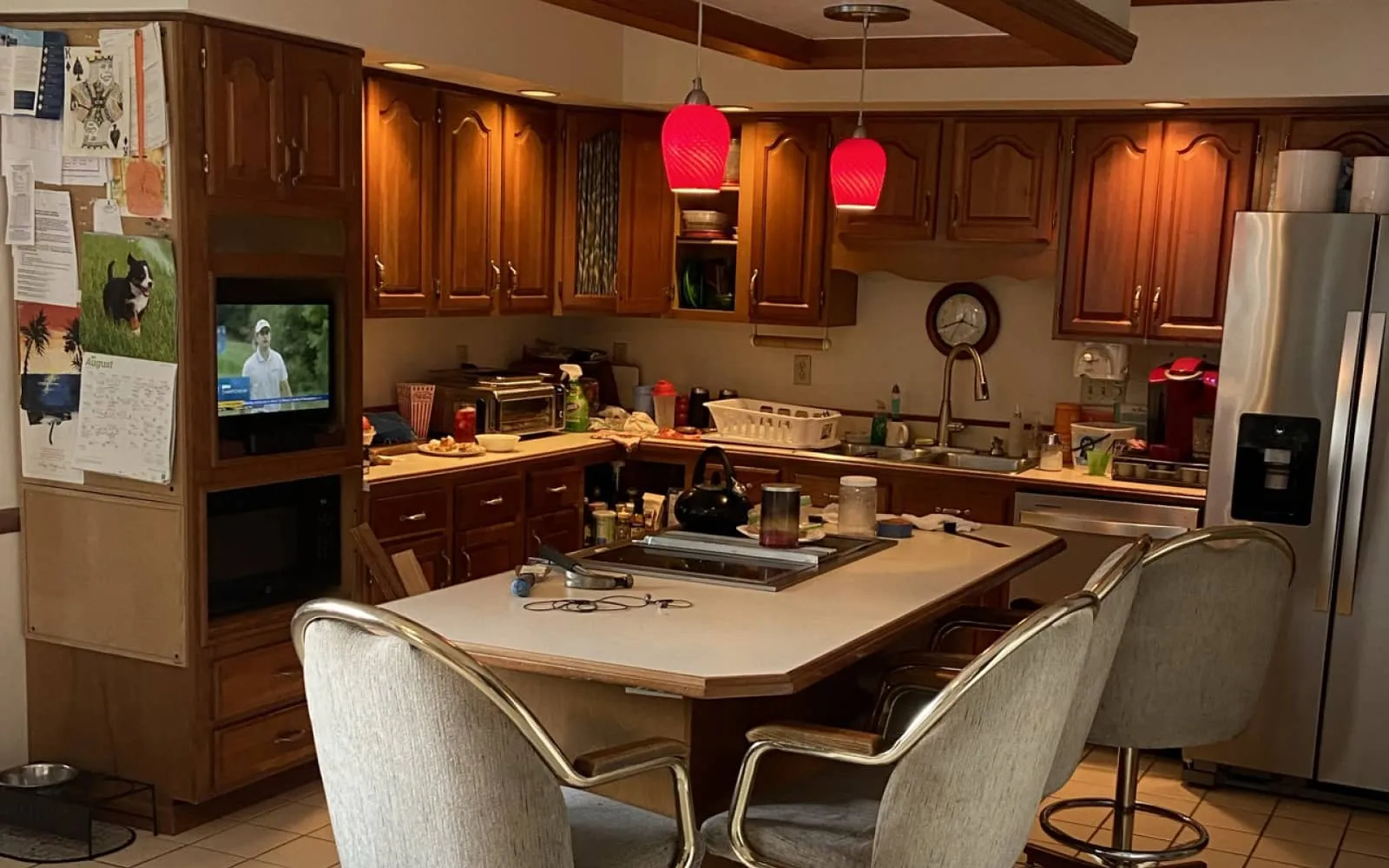a kitchen with a tv and chairs