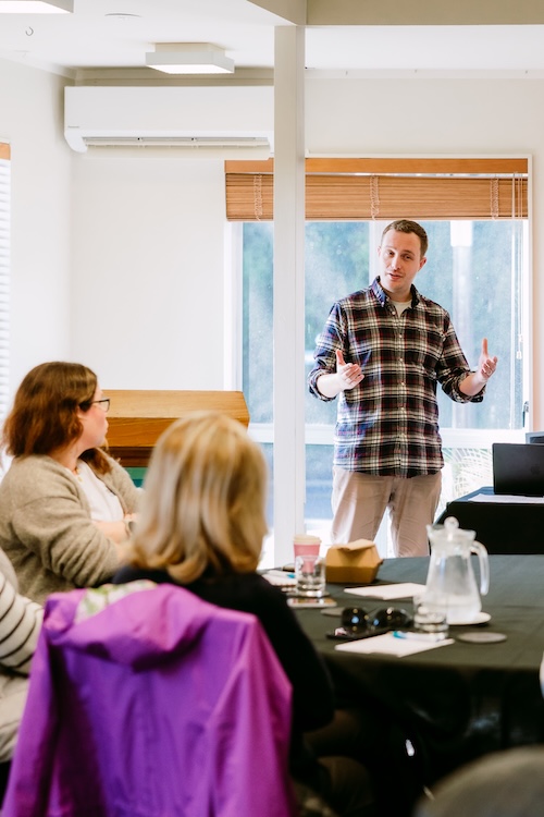 Picture of Tom helping a cohort