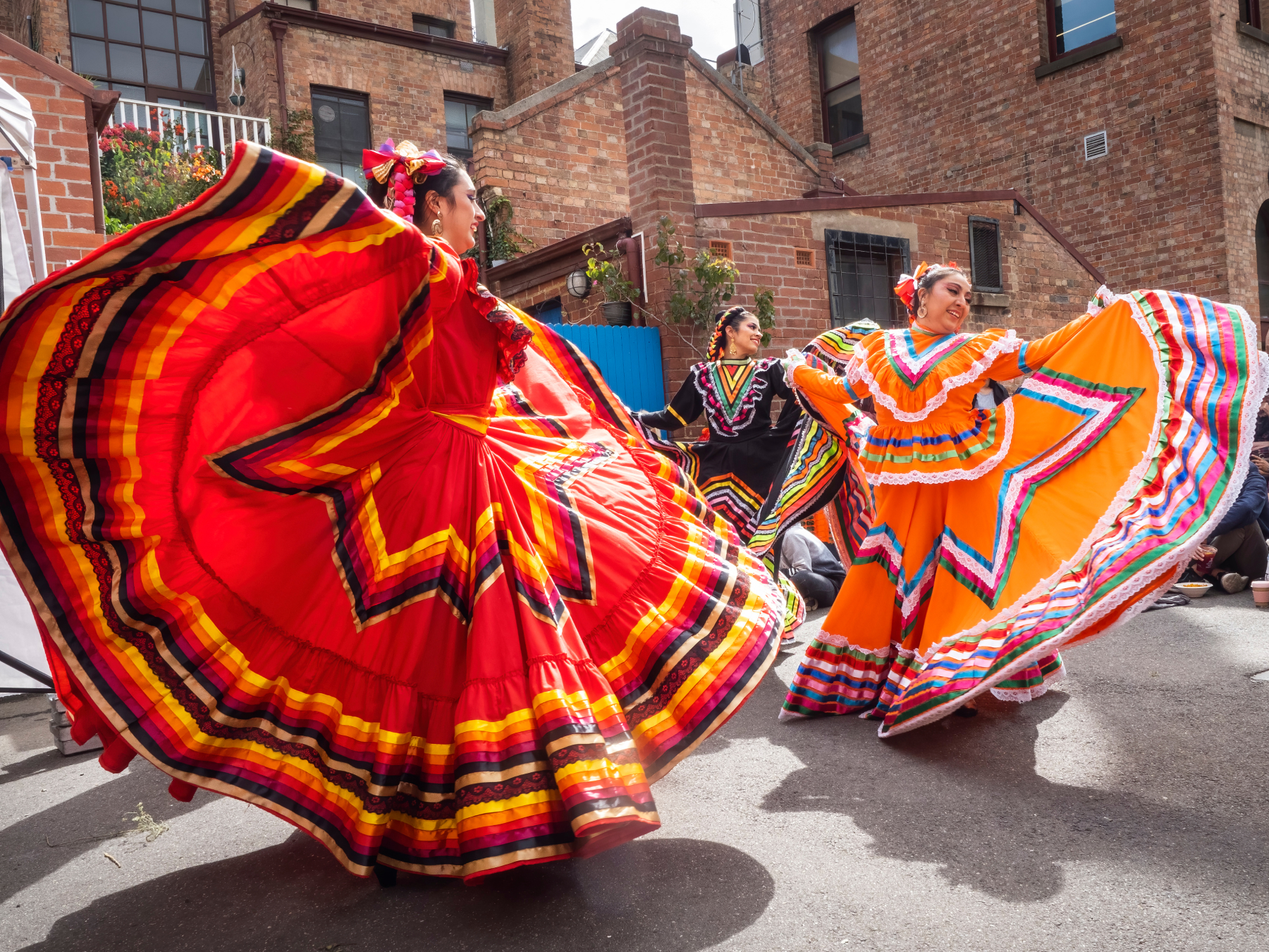 Three colourful latin dancers