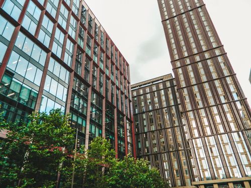 A couple of tall buildings sitting next to each other.