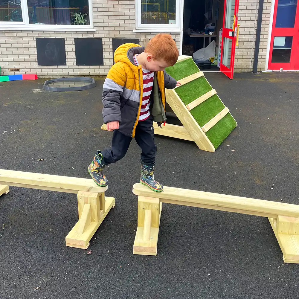 A nursery child balancing on an Exercise Balance Set