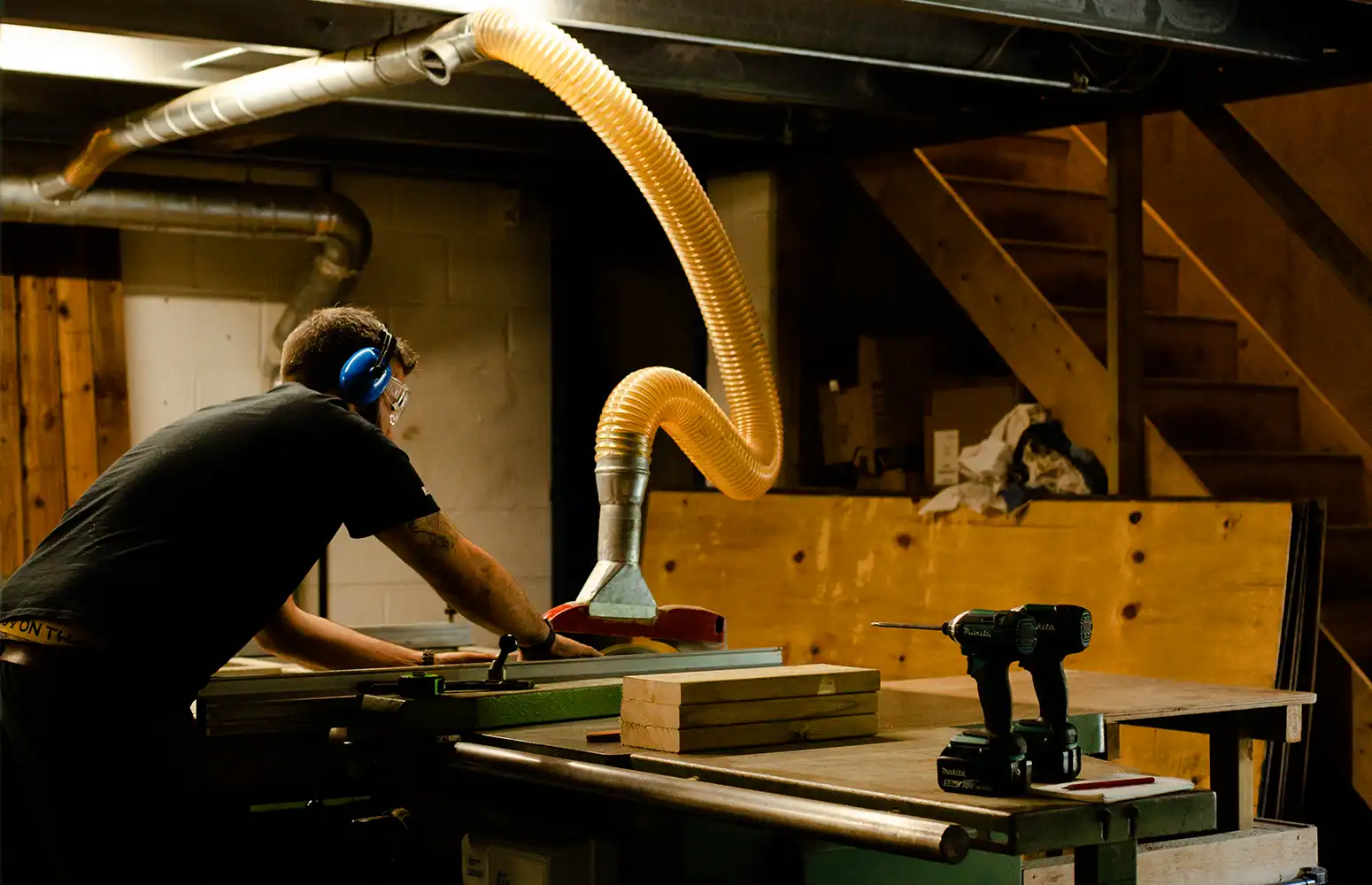 Using our rip saw to prepare the wood for manufacturing