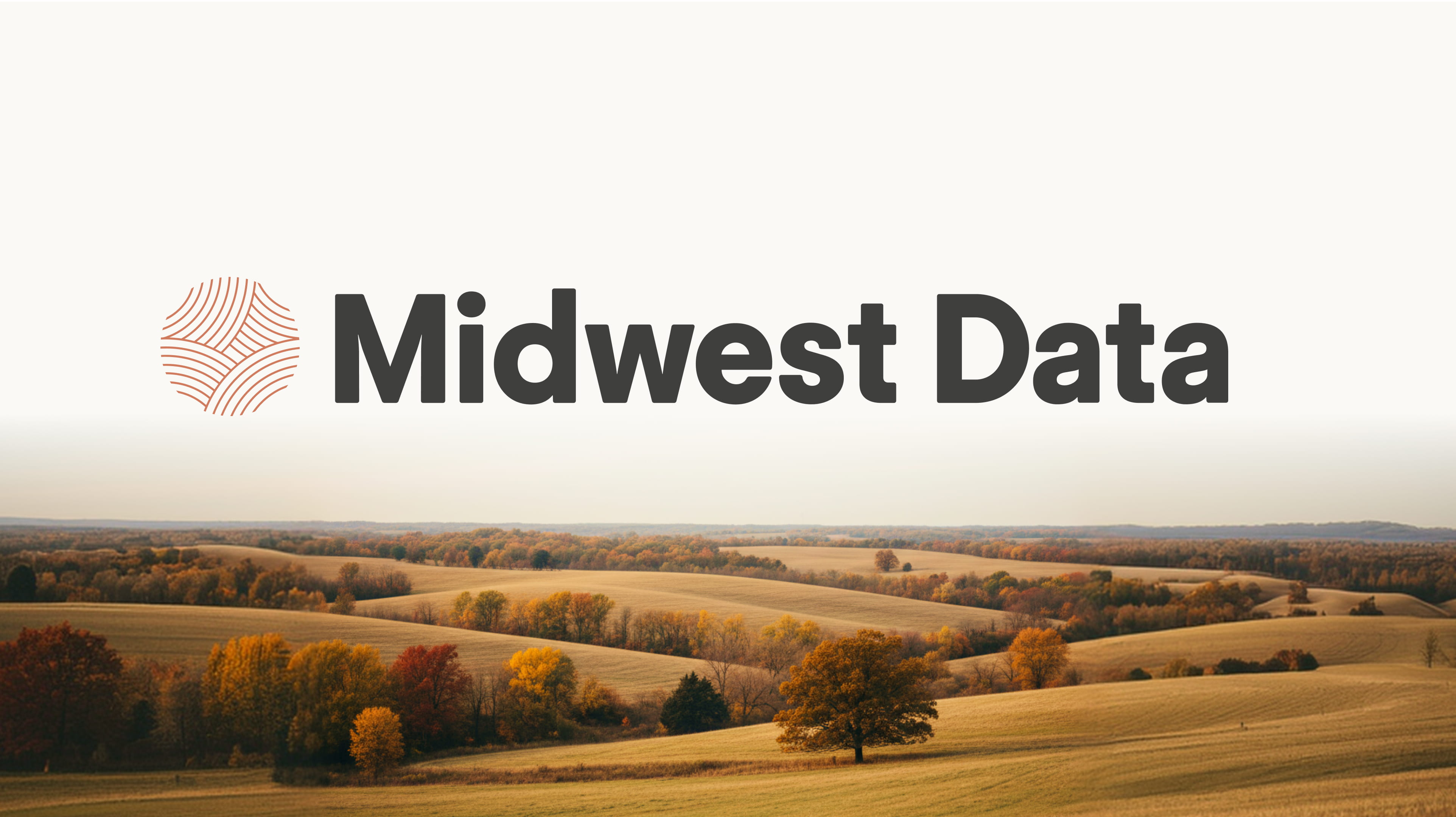 Rolling Midwest hills with autumn trees under a light sky and Midwest Data logo above.